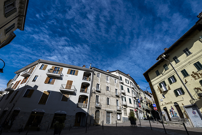 Piazza del centro storico di Ivrea con facciate e balconi tradizionali sotto un cielo azzurro
